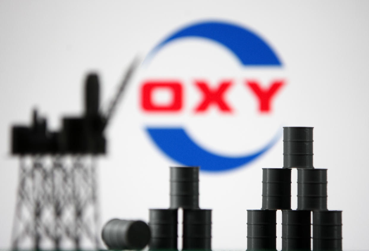 Occidental Petroleum Corporation (OXY) logo and models of an oil rig and oil barrels are pictured in this illustration photo taken in Kyiv on 19 August, 2021. (Photo by STR/NurPhoto via Getty Images)