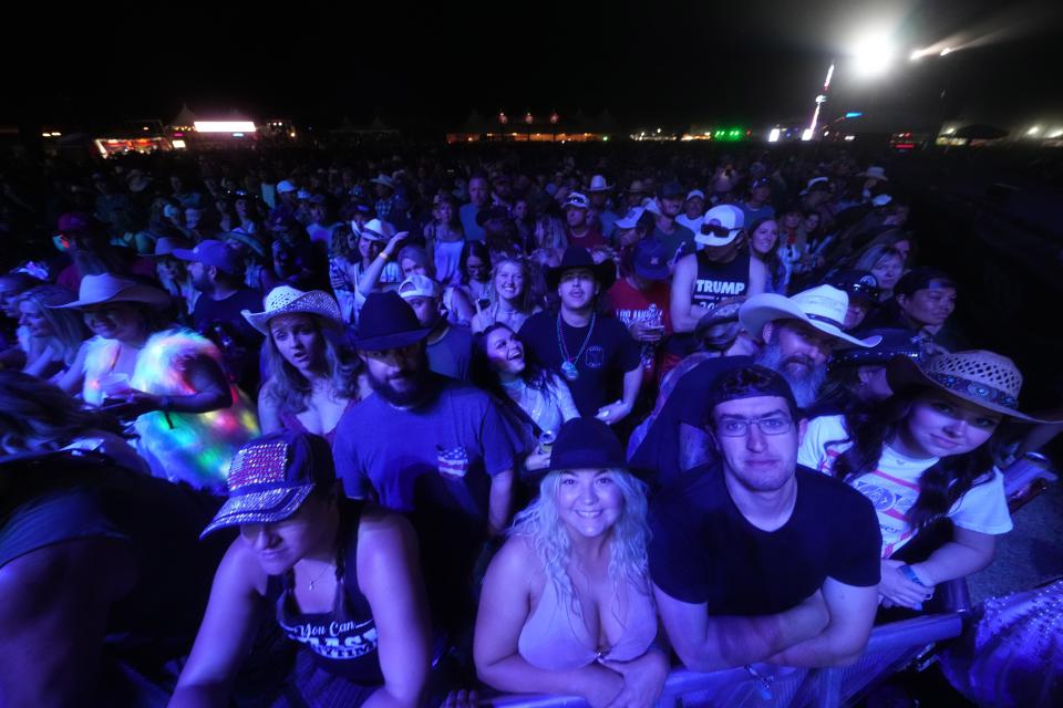 Fans listen as Ashley McBryde performs with her band at the Country Thunder Music Festival on April 14, 2023.