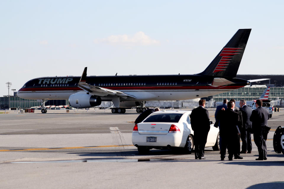 Secret Service agents are seen in front of U.S. President-elect Donald Trump's airplane as it taxis at LaGuardia Airport en route to Indiana from New York, U.S., December 1, 2016. REUTERS/Mark Kauzlarich