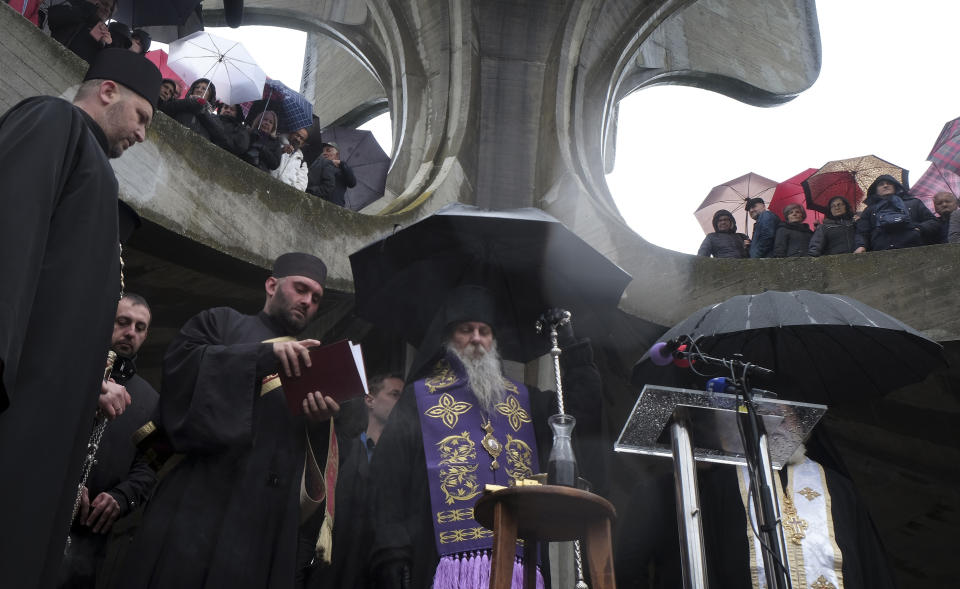 A religious service is held at the memorial center for tens of thousands of people killed in death camps run by Croatia's pro-Nazi puppet state in WWII, in Jasenovac, Croatia, Friday, April 12, 2019. Croatia's Jewish, Serb, anti-fascist and Roma groups have commemorated the victims of a World War II death camp, snubbing the official ceremonies for the fourth year in a row over what they say is government inaction to curb neo-Nazi sentiments in the European Union country. (AP Photo/Nikola Solic)