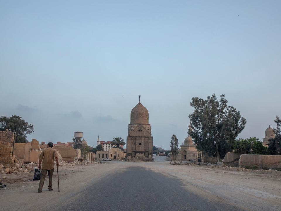 A man looks at graves demolished to make way for a new highway in Cairo, in 2020.