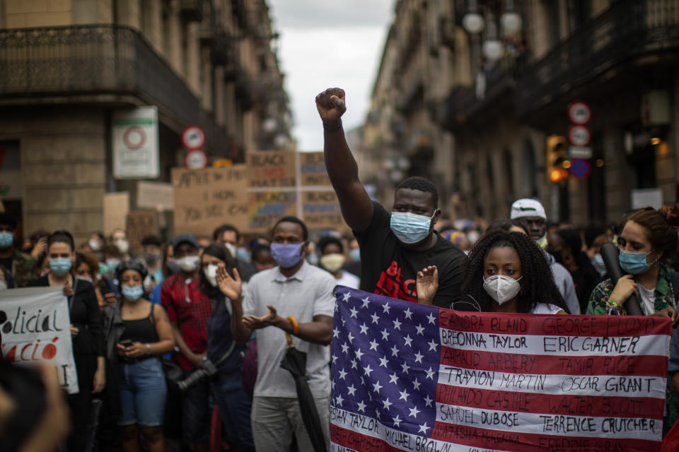 People gather in Barcelona, Spain, Sunday, June 7, 2020, during a demonstration over the death of George Floyd, a black man who died after being restrained by Minneapolis police officers on May 25. (AP Photo/Emilio Morenatti)