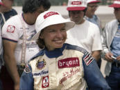 In this 1977 photo provided by Indianapolis Motor Speedway, driver Janet Guthrie smiles at Indianapolis Motor Speedway in Indianapolis, Ind. There was no warm reception for Janet Guthrie when she arrived at Indianapolis Motor Speedway 43 years ago. She wanted a spot in the biggest race in the world and her competitors didn't want her anywhere near the Indianapolis 500. (Indianapolis Motor Speedway via AP)