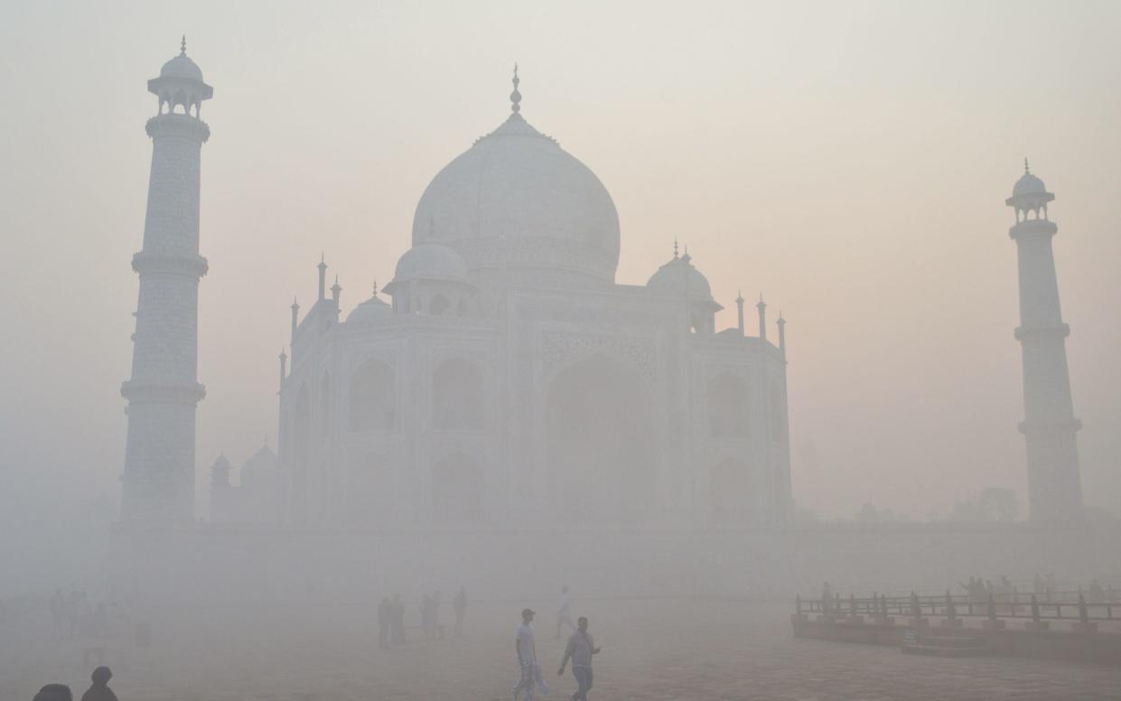 Tourist visit the Taj Mahal amid heavy smog conditions in Agra on November 23, 2023