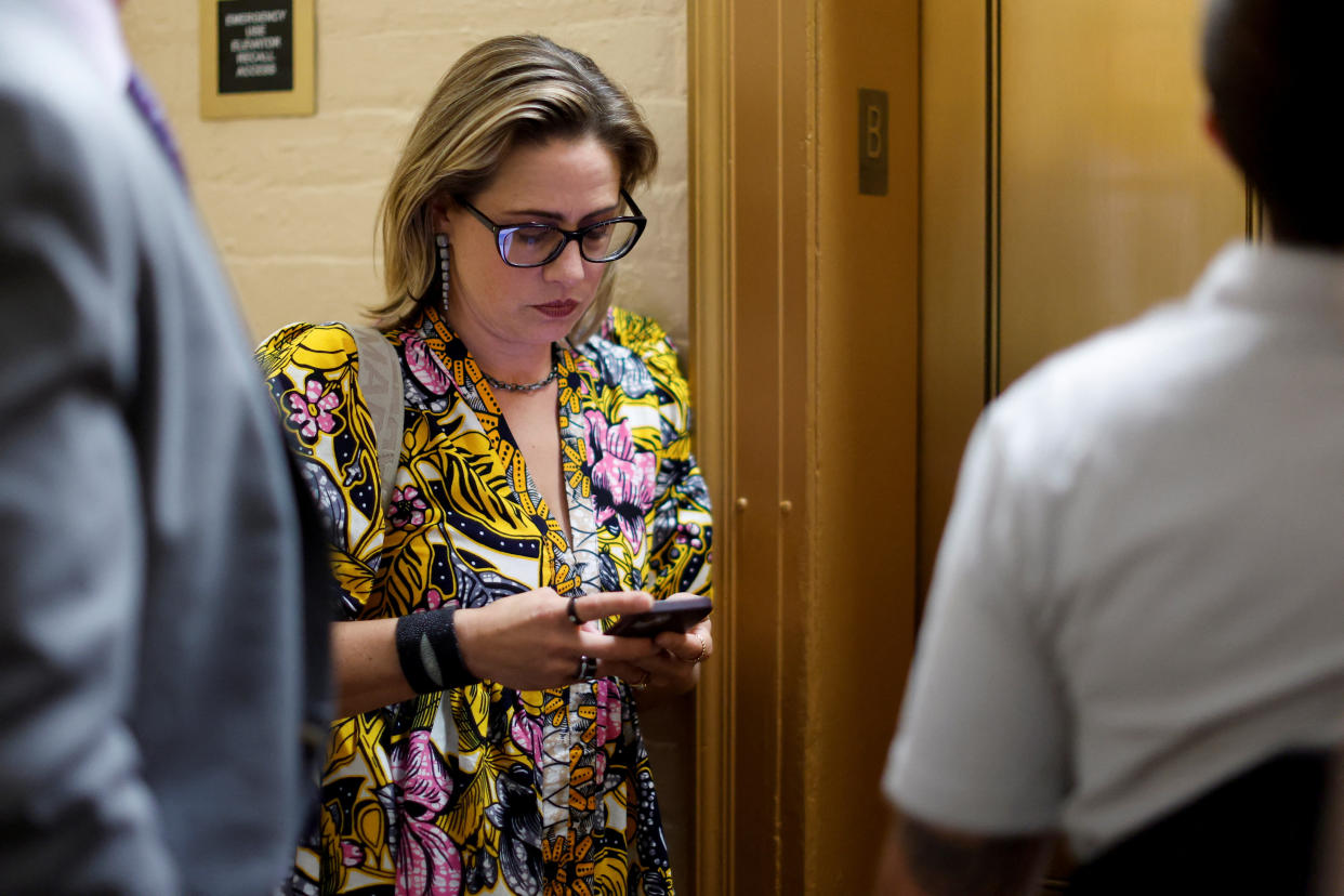 U.S. Senator Kyrsten Sinema (D-AZ) waits for an elevator to go to the Senate floor at the U.S. Capitol in Washington, U.S. August 2, 2022.  REUTERS/Jonathan Ernst