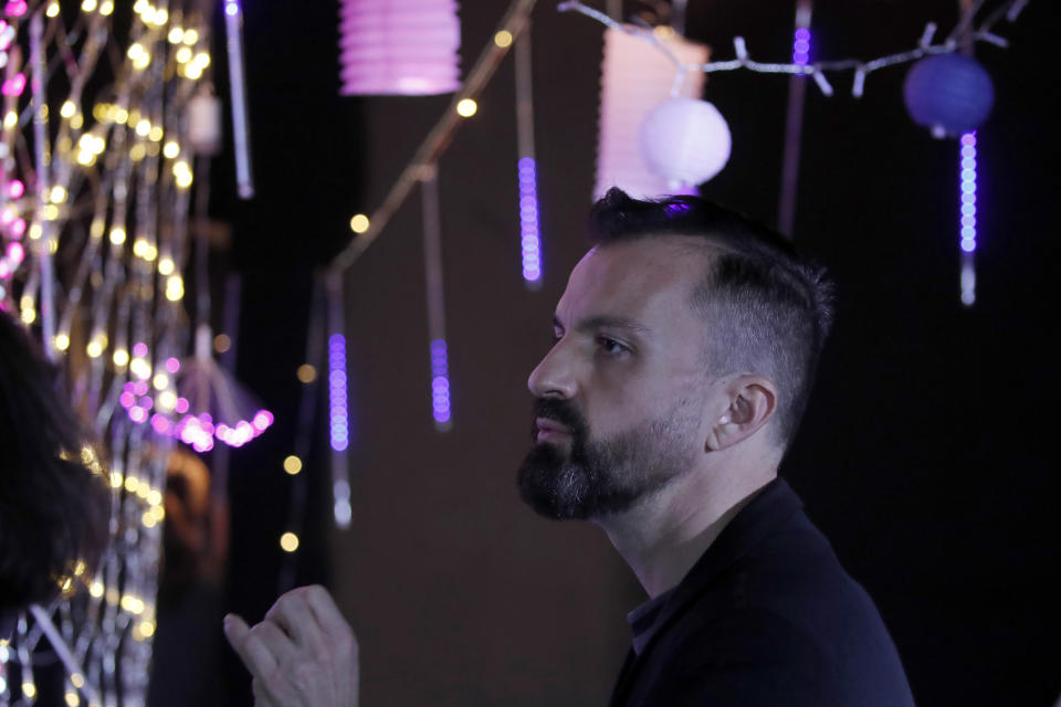 French designer Julien Fournie gives instructions to the models during the shoot for his Haute Couture Spring/Summer 2021 fashion collection for a digital presentation of the fashion week, in Paris, Thursday, Jan. 7, 2021. With shows taking place behind closed doors due to the virus pandemic, some designers such as Julien Fournie are becoming versatile: Getting their designs out to the public by making a film of their collection and streaming it online. (AP Photo/Francois Mori)