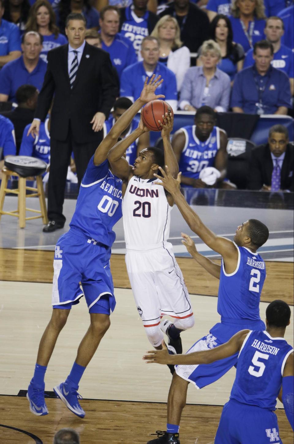 Connecticut guard Lasan Kromah (20) drives to the basket between Kentucky's Marcus Lee (00) and Aaron Harrison (2) during the first half of the NCAA Final Four tournament college basketball championship game Monday, April 7, 2014, in Arlington, Texas. (AP Photo/Tony Gutierrez)