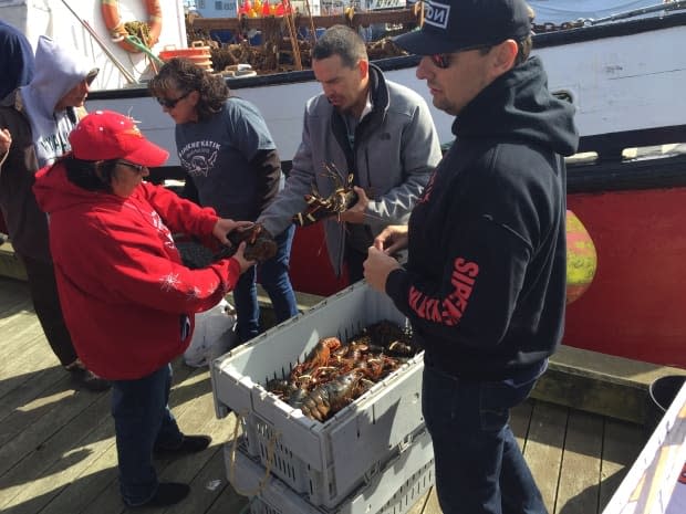 Sipekne'katik First Nation Chief Michael Sack, right, is shown with other band member last fall at the wharf in Saulnierville, N.S. (Paul Withers/CBC - image credit)