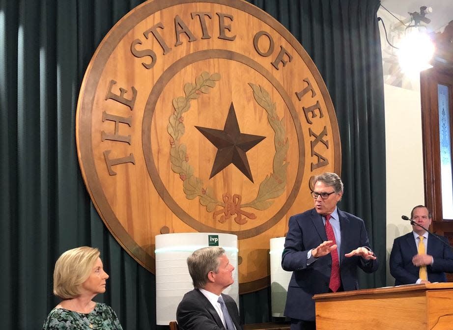 Former Gov. Rick Perry speaks at a news conference in the Texas Capitol in 2021.