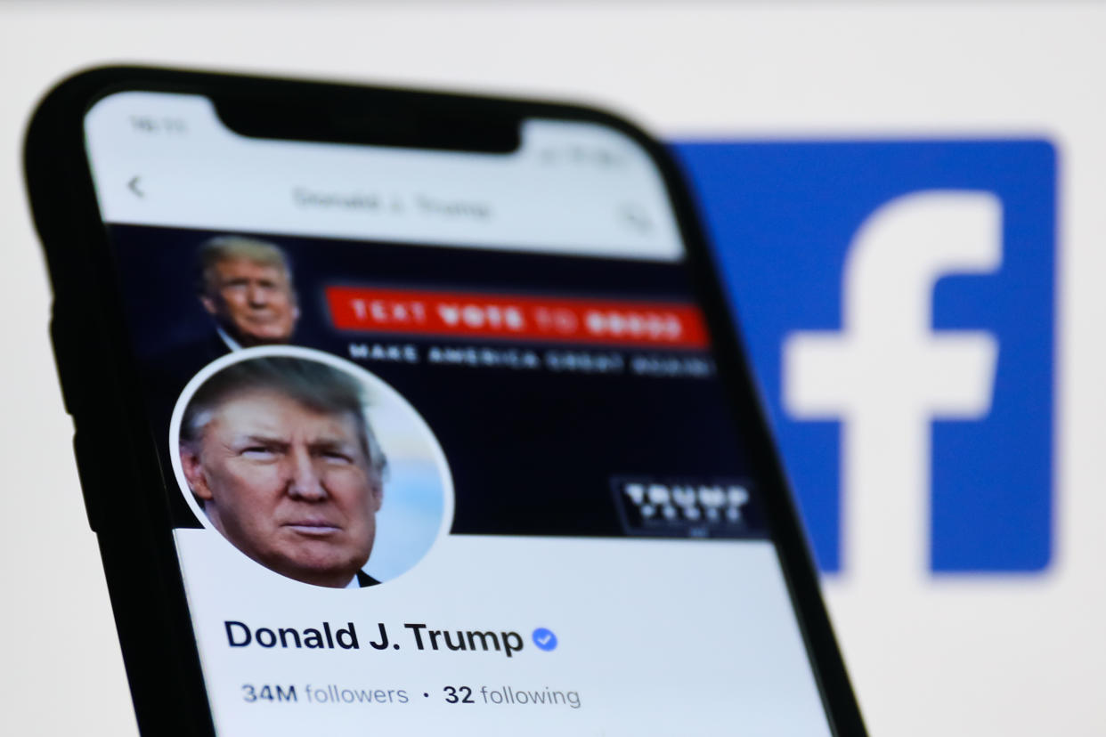 Donald Trump account on Facebook displayed on a phone screen and Facebook logo displayed on a screen in the background are seen in this illustration photo taken in Krakow, Poland on January 26, 2023. (Photo by Jakub Porzycki/NurPhoto via Getty Images)