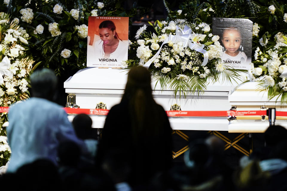 Mourners pay their respects for the victims of a deadly row house fire during funeral services at Temple University in Philadelphia, Monday, Jan. 17, 2022. Officials say it was the city's deadliest single fire in at least a century. (AP Photo/Matt Rourke)