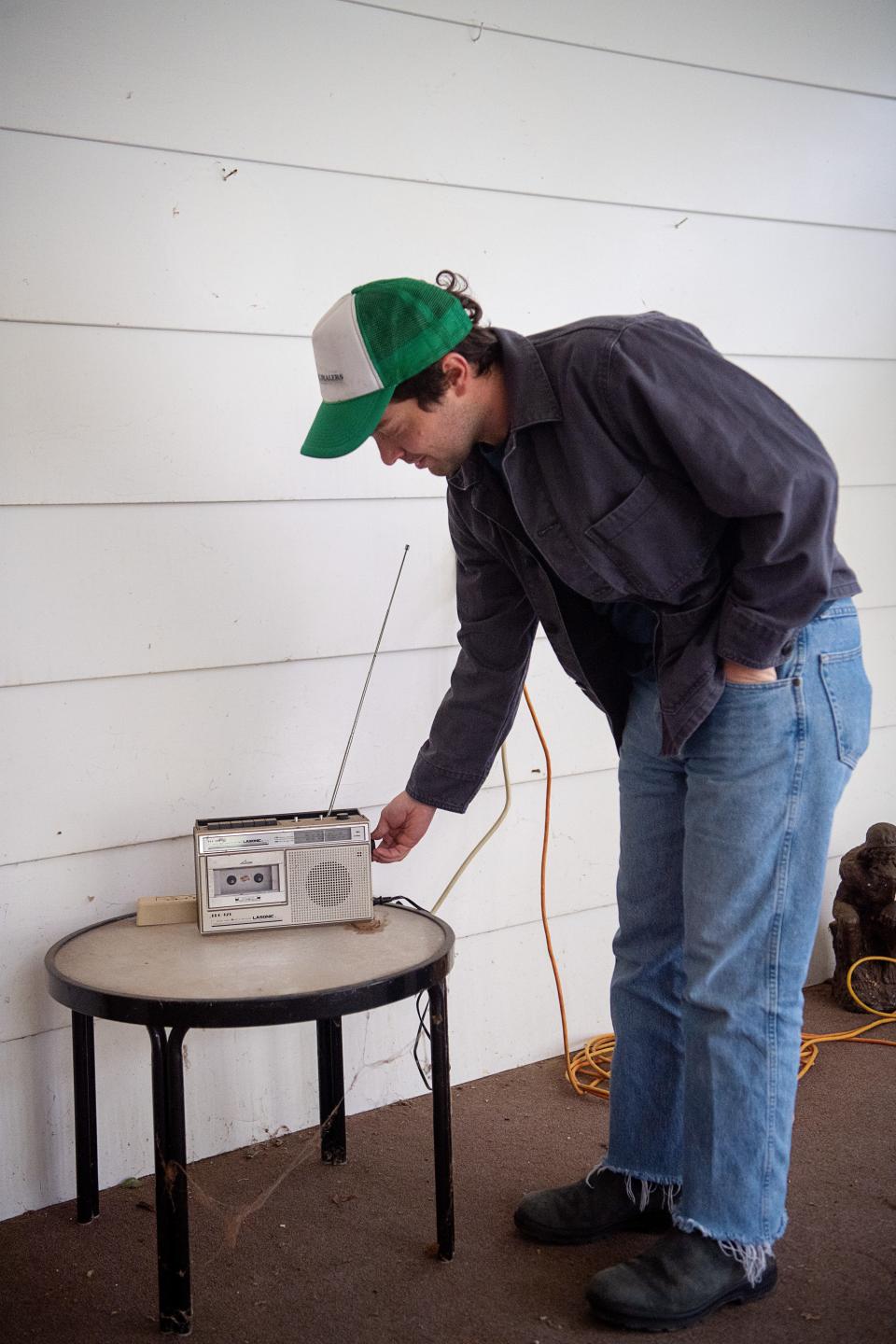 Colin Miller adjusts Gary King’s radio in Haw Creek, April 4, 2024.