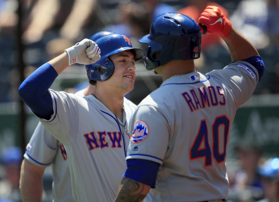 New York Mets' Michael Conforto, left, celebrates this three-run home run with teammate Wilson Ramos (40) during the first inning of a baseball game against the Kansas City Royals at Kauffman Stadium in Kansas City, Mo., Sunday, Aug. 18, 2019. (AP Photo/Orlin Wagner)