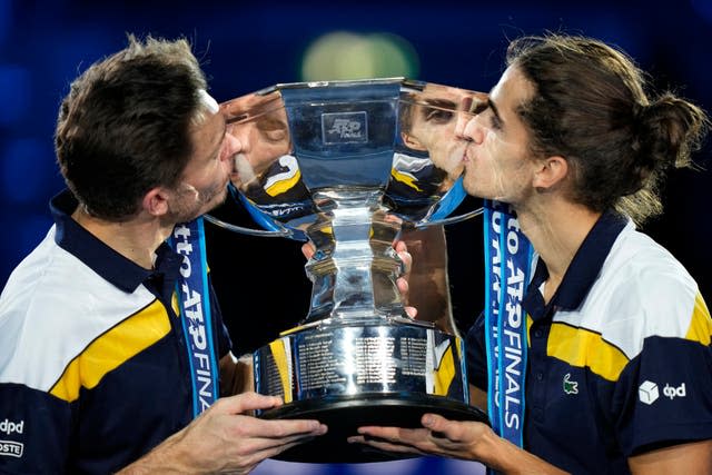 France’s Pierre-Hugues Herbert, right, and Nicolas Mahut kiss the trophy