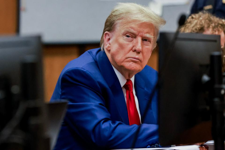 Former President Donald Trump attends a hearing to determine the date of his trial for allegedly covering up hush money payments linked to extramarital affairs, at Manhattan Criminal Court in New York City on March 25, 2024. Trump faces twin legal crises today in New York, where he could see the possible seizure of his storied properties over a massive fine as he separately fights to delay a criminal trial even further.