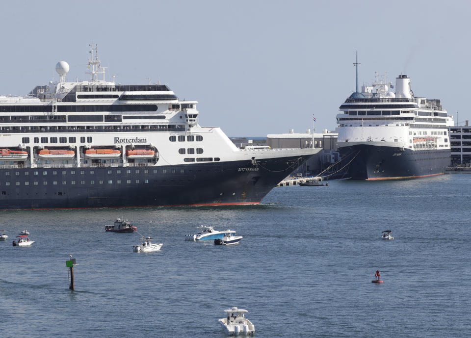 The cruise ship Rotterdam, left, passes the Zaandam, right as it prepares to dock at Port Everglades, Thursday, April 2, 2020, in Fort Lauderdale, Fla. The Zaandam and Rotterdam cruise ships carrying guests and crew with flu-like symptoms will be allowed to dock in Florida's Port of Everglades Thursday, ending a nightmarish voyage disrupted by the coronavirus pandemic.(AP Photo/Wilfredo Lee)