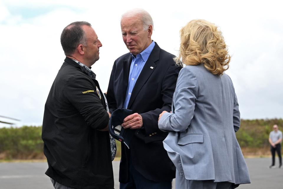 US President Joe Biden and US First Lady Jill Biden greet Hawaii Governor Josh Green (L) upon arrival at Kahului Airport in Kahului, Hawaii, on August 21, 2023. (AFP via Getty Images)