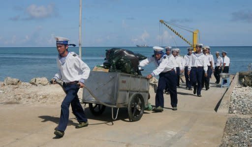 Vietnamese sailors walk from a ship which has just arrived at Truong Sa Dong island in the Spratly archipelargo. Vietnam will hold a live-fire drill in the South China Sea next week, the navy announced on Friday, as a maritime dispute fuels tensions with China