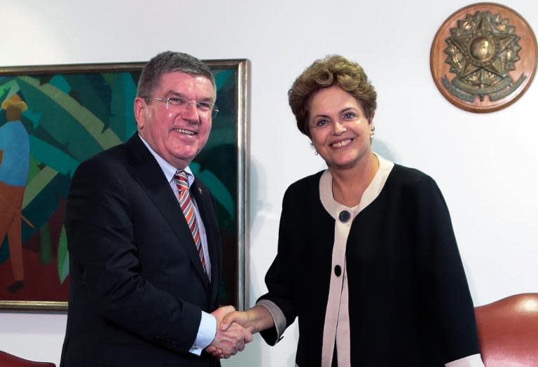 The President of Brazil Dilma Rousseff greets the president of the International Olympic Committee, Thomas Bach, at the presidential palace in Brasilia, on February 24, 2015