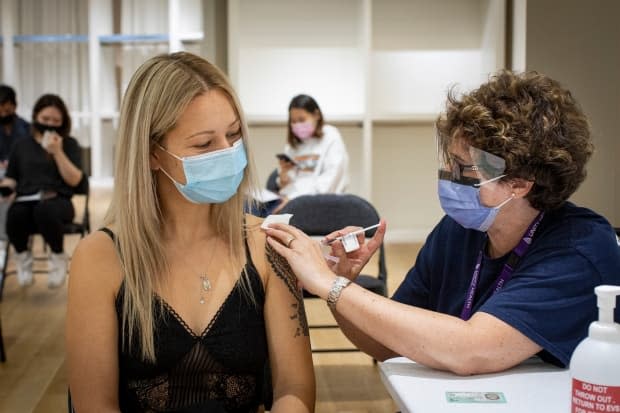 Ontario's new vaccine passport system applies to the indoor areas of restaurants, bars, gyms, cinemas and many other venues. Provincial ministry of health figures show more than 10.3 million people have had two doses of vaccine, which amounts to 79 per cent of the eligible population.    (Evan Mitsui/CBC - image credit)