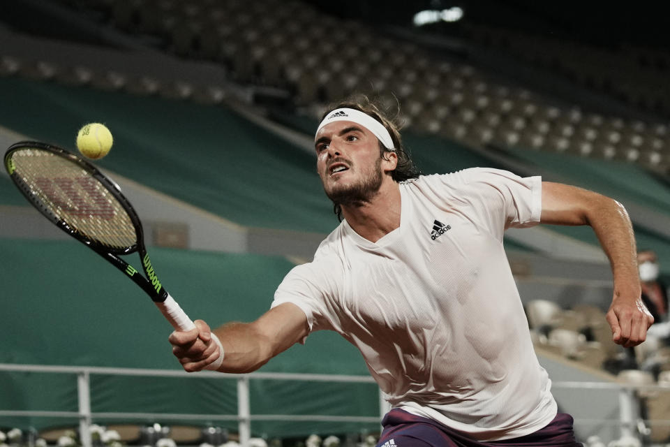 Stefanos Tsitsipas of Greece returns the ball to Russia's Daniil Medvedev during their quarterfinal match of the French Open tennis tournament at the Roland Garros stadium Tuesday, June 8, 2021 in Paris. (AP Photo/Thibault Camus)