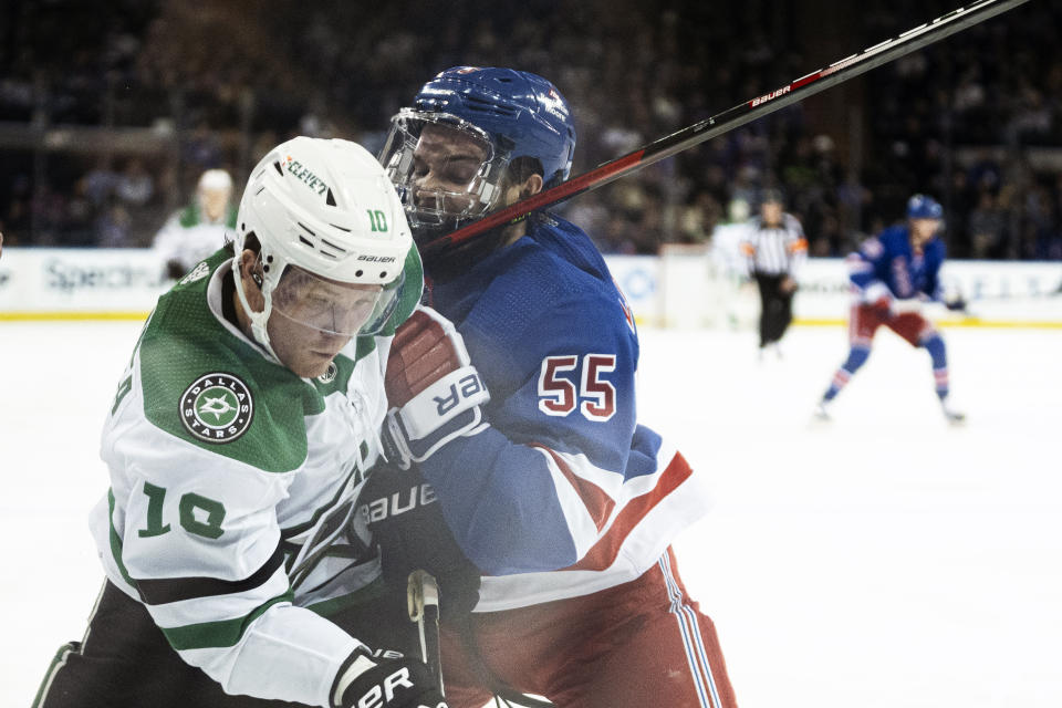 Dallas Stars center Ty Dellandrea (10) is checked by New York Rangers defenseman Ryan Lindgren (55) during the first period of an NHL hockey game on Tuesday, Feb. 20, 2024 in New York. (AP Photo/Peter K. Afriyie)