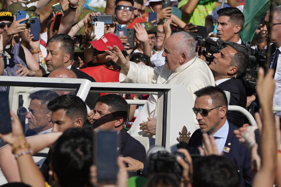 Pope Francis waves on arrival to preside over a via crucis (Way of the Cross) at the Eduardo VII Park with young people in Lisbon, Friday, Aug. 4, 2023. Pope Francis is on the third day of a five-day pastoral visit to Portugal that includes the participation at the 37th World Youth Day, and a pilgrimage to the holy shrine of Fatima. (AP Photo/Gregorio Borgia)