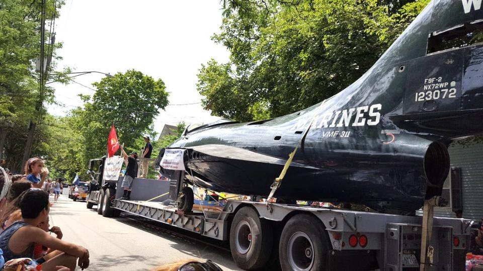 Volunteers from the Rhode Island Aviation Hall of Fame ready an F9F Panther jet for the 2018 Bristol Fourth of July Parade. The aircraft represented the plane that Red Sox star Ted Williams flew during the Korean War, and was repainted with his markings.