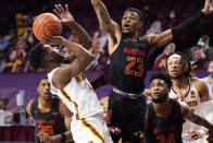 Minnesota's Jamal Mashburn Jr., left, attempts a shot as Maryland's Aquan Smart defends in the first half of an NCAA college basketball game, Saturday, Jan. 23, 2021, in Minneapolis. (AP Photo/Jim Mone)