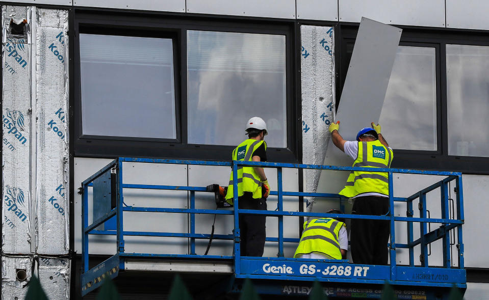 <p>Workers remove cladding from Whitebeam Court, in Pendleton, Manchester, Monday June 26, 2017. The list of high-rise apartment towers in Britain that have failed fire safety tests grew to 60, officials said Sunday, revealing the mounting challenge the government faces in the aftermath of London’s Grenfell Tower fire tragedy. (Photo: Peter Byrne/PA via AP) </p>