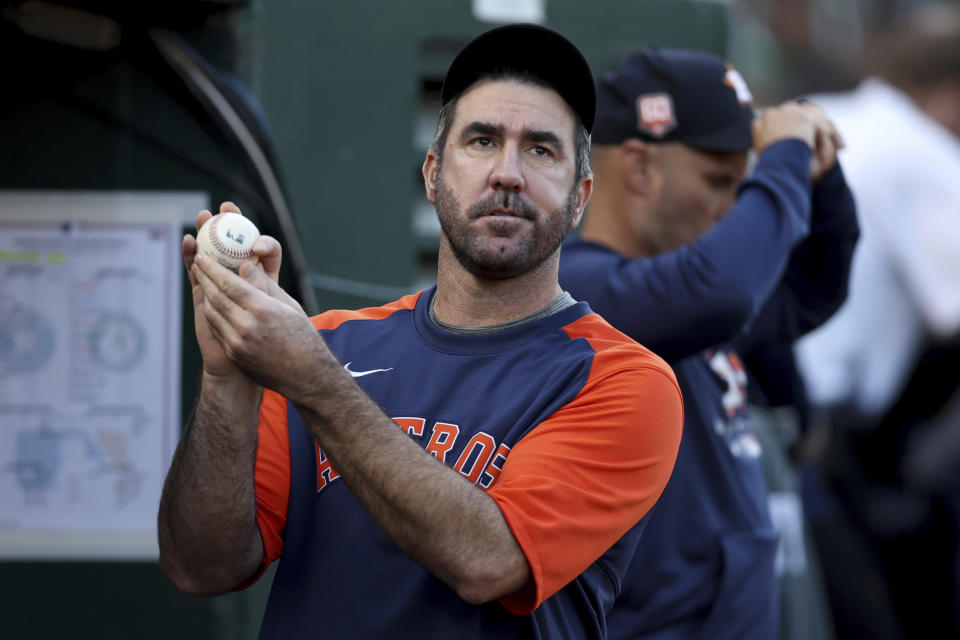 Houston Astros' Justin Verlander stands in the dugout during the third inning of the team's baseball game against the Oakland Athletics in Oakland, Calif., Tuesday, May 31, 2022. (AP Photo/Jed Jacobsohn)