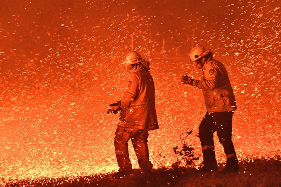 australia brush fires brushfires firefighters flames blaze hose water embers GettyImages 1191119032