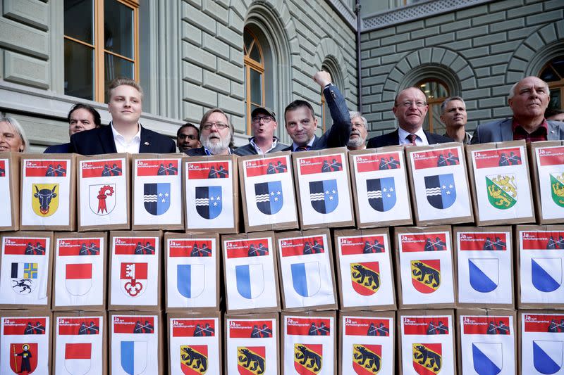 FILE PHOTO: National Councillor Wobmann and members initiative committee for "Yes to a Mask Ban" hand over boxes with signatures in Bern