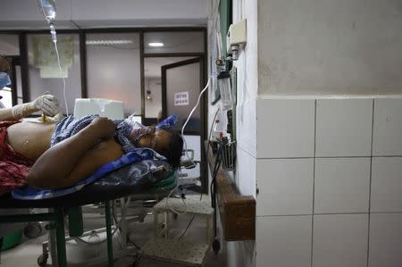 A landslide victim undergoes treatment at a hospital in Kathmandu after being rescued from a landslide in northeast Nepal August 2, 2014. REUTERS/Navesh Chitrakar