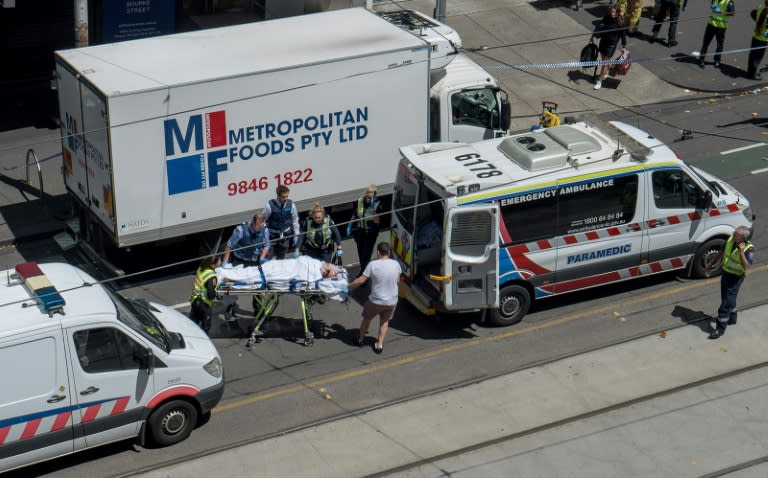 Paramedics help injured people after a car drove into pedestrians in the centre of Melbourne on January 20, 2017