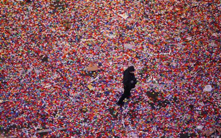A policeman walks through confetti after it was dropped on revelers at midnight during New Year's Eve celebrations in Times Square in New York January 1, 2014. REUTERS/Gary Hershorn