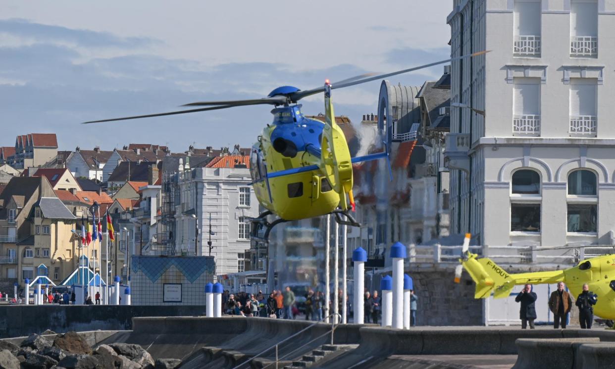 <span>An emergency helicopter takes off after the recovery of the bodies of five people who died trying to cross the Channel.</span><span>Photograph: Bernard Barron/AFP/Getty Images</span>