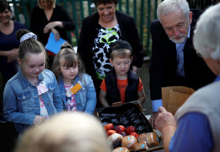 Britain's opposition Labour party leader, Jeremy Corbyn, helps fill childrens packed lunches outside the Hope Centre in Bolton, Britain August 17, 2017. REUTERS/Phil Noble