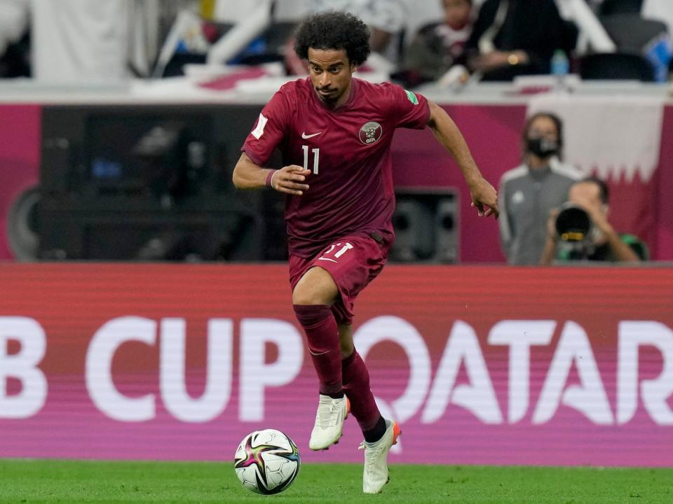 Akram Afif dribbles the ball during a Qatar soccer match.