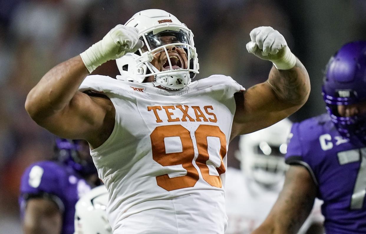 Texas Longhorns defensive lineman Byron Murphy II (90) celebrates after a sack against TCU Horned Frogs quarterback Josh Hoover (10) in the second quarter of an NCAA college football game, Saturday, November. 11, 2023, at Amon G. Carter Stadium in Fort Worth, Texas.