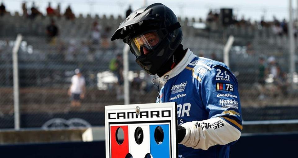 Hendrick Motorsports pit development manager Evan Kureczka holds the pit sign at the Garage 56 pit stall during Sunday\