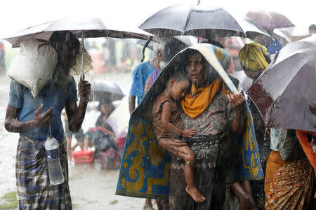 Rohingya refugees stands in an open place during heavy rain, as they are hold by Border Guard Bangladesh (BGB) after illegally crossing the border, in Teknaf, Bangladesh, August 31, 2017. REUTERS/Mohammad Ponir Hossain