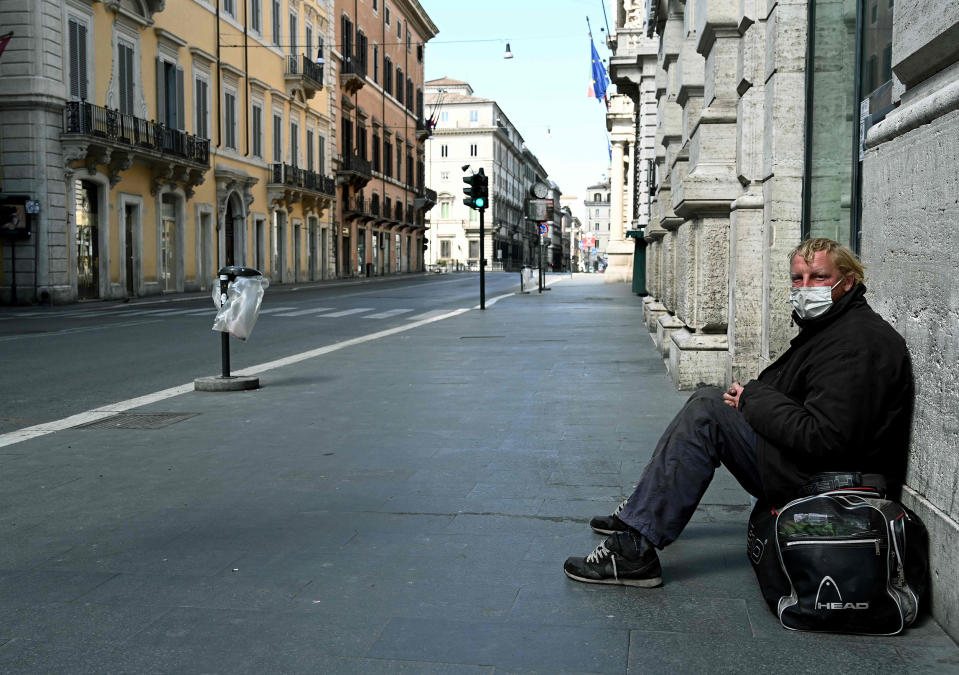 Image: A homeless man sits in Via del Corso in Rome (Vincenzo Pinto / AFP - Getty Images)