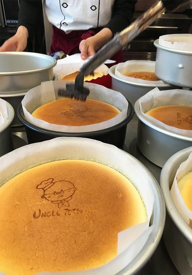 The plump Uncle Tetsu character is then branded onto the cheesecake. Photo: Yahoo7 Be