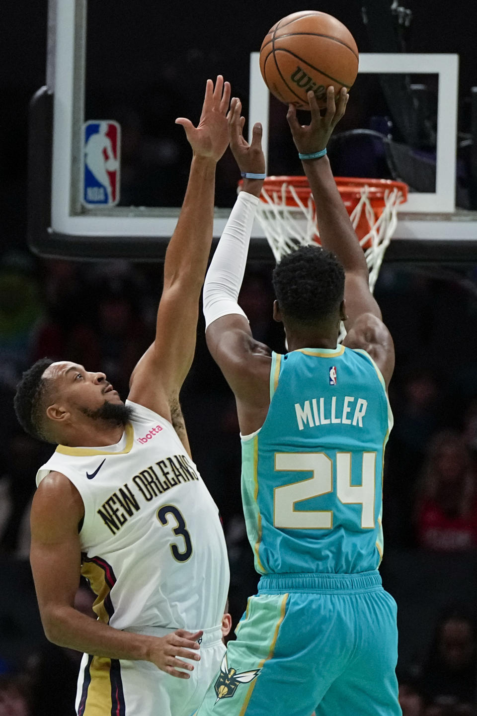 Charlotte Hornets forward Brandon Miller shoots over New Orleans Pelicans guard CJ McCollum during the first half of an NBA basketball game Friday, Dec. 15, 2023, in Charlotte, N.C. (AP Photo/Chris Carlson)