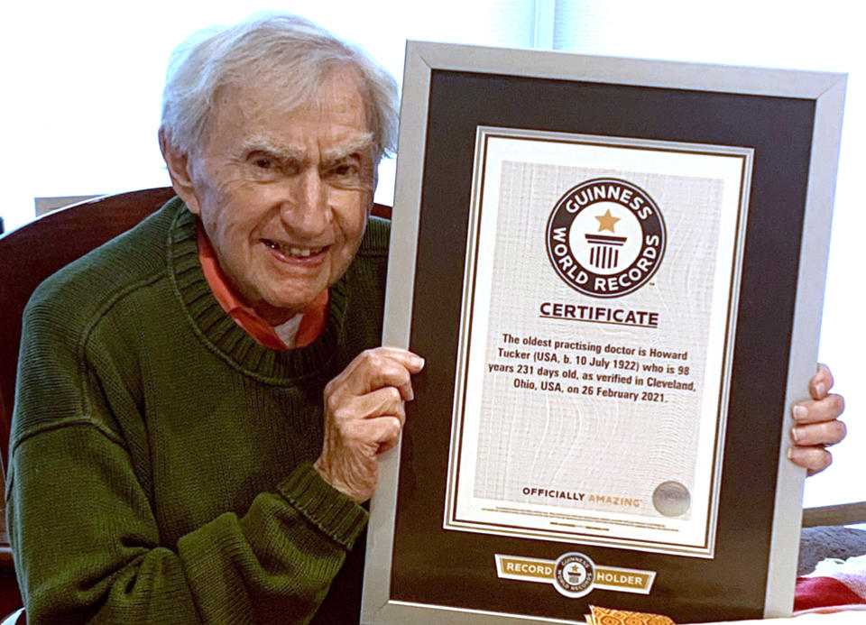 Tucker holds his Guinness World Records certificate recognizing him as the world's oldest practicing doctor. (Courtesy Tucker family)