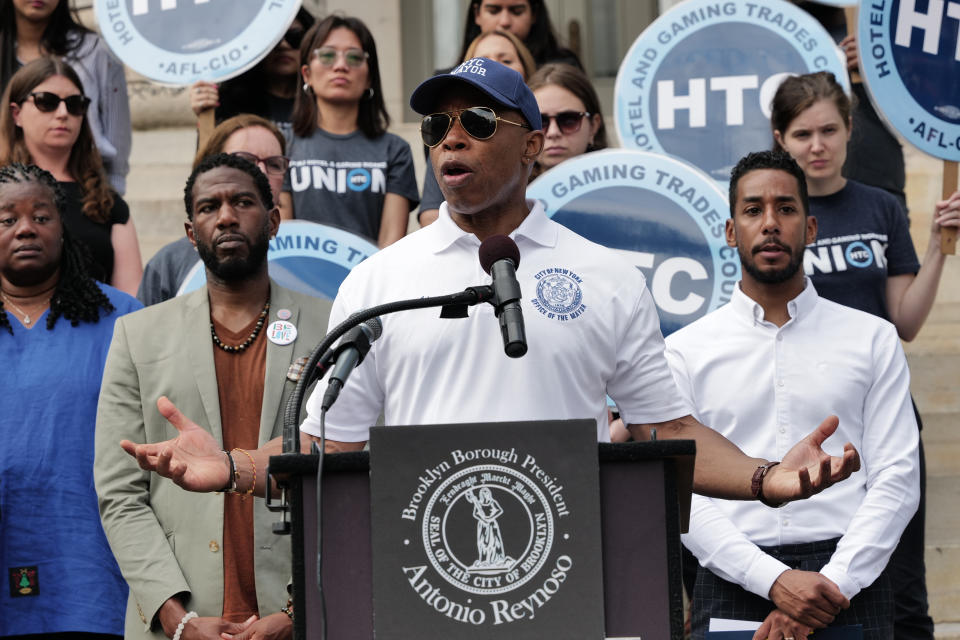 New York Mayor Eric Adams speaks at a podium.