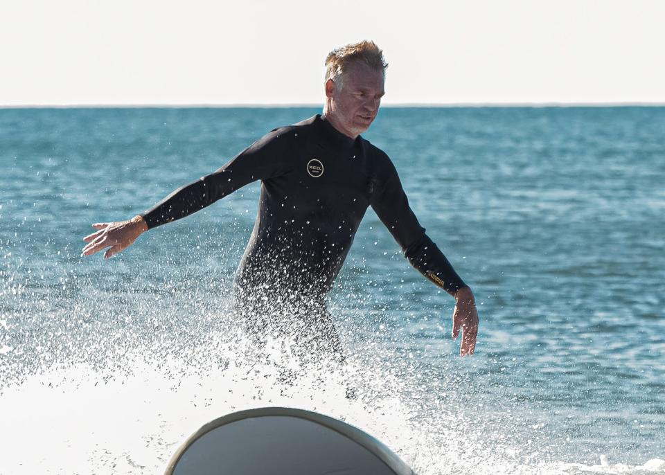 Dave Cropper, owner of Cinnamon Rainbows Surf Co., while filming for an episode of "Explore New England" that will feature recreation at Hampton Beach.