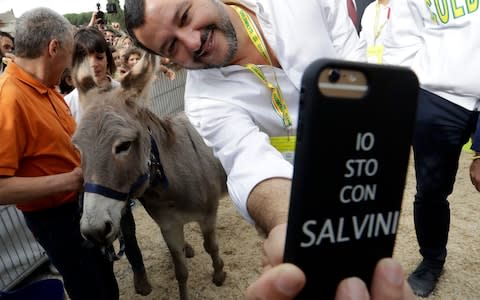 Matteo Salvini, takes selfies as he visits a Coldiretti farmers association event in Rome's CIrcus Maximus - Credit: AP