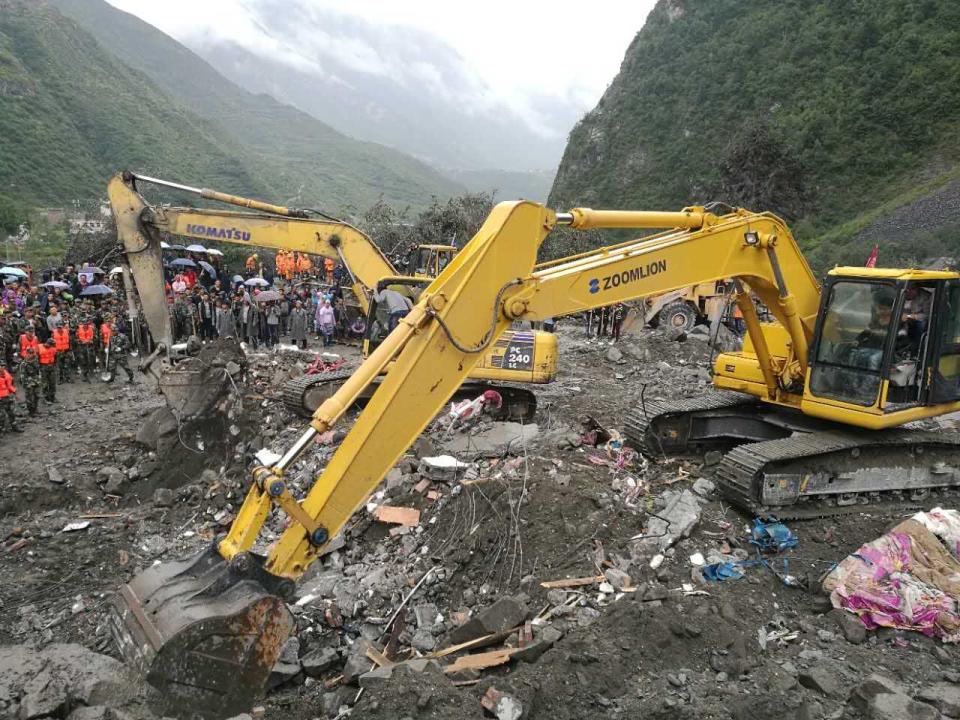 <p>The excavator works at the accident site after a landslide at Xinmo Village of Maoxian County on June 24, 2017 in Tibetan and Qiang Autonomous Prefecture, Sichuan Province of China. (Photo: VCG/VCG via Getty Images) </p>